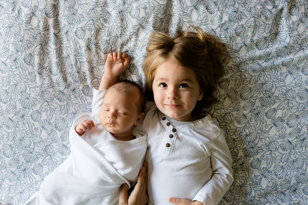 newborn baby with sister