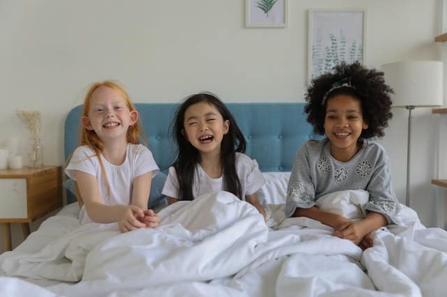 kids smiling bed