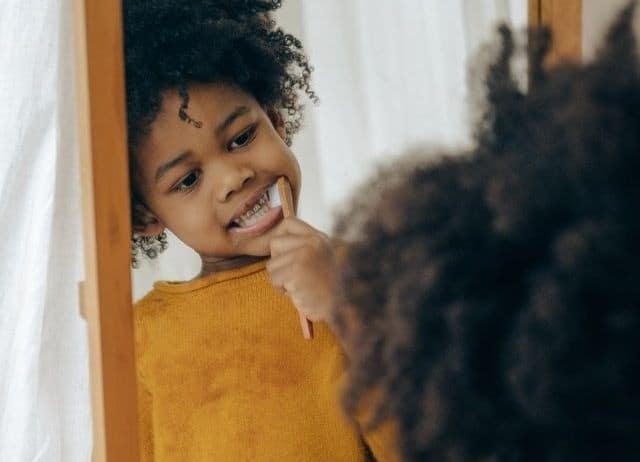 boy afro brushing