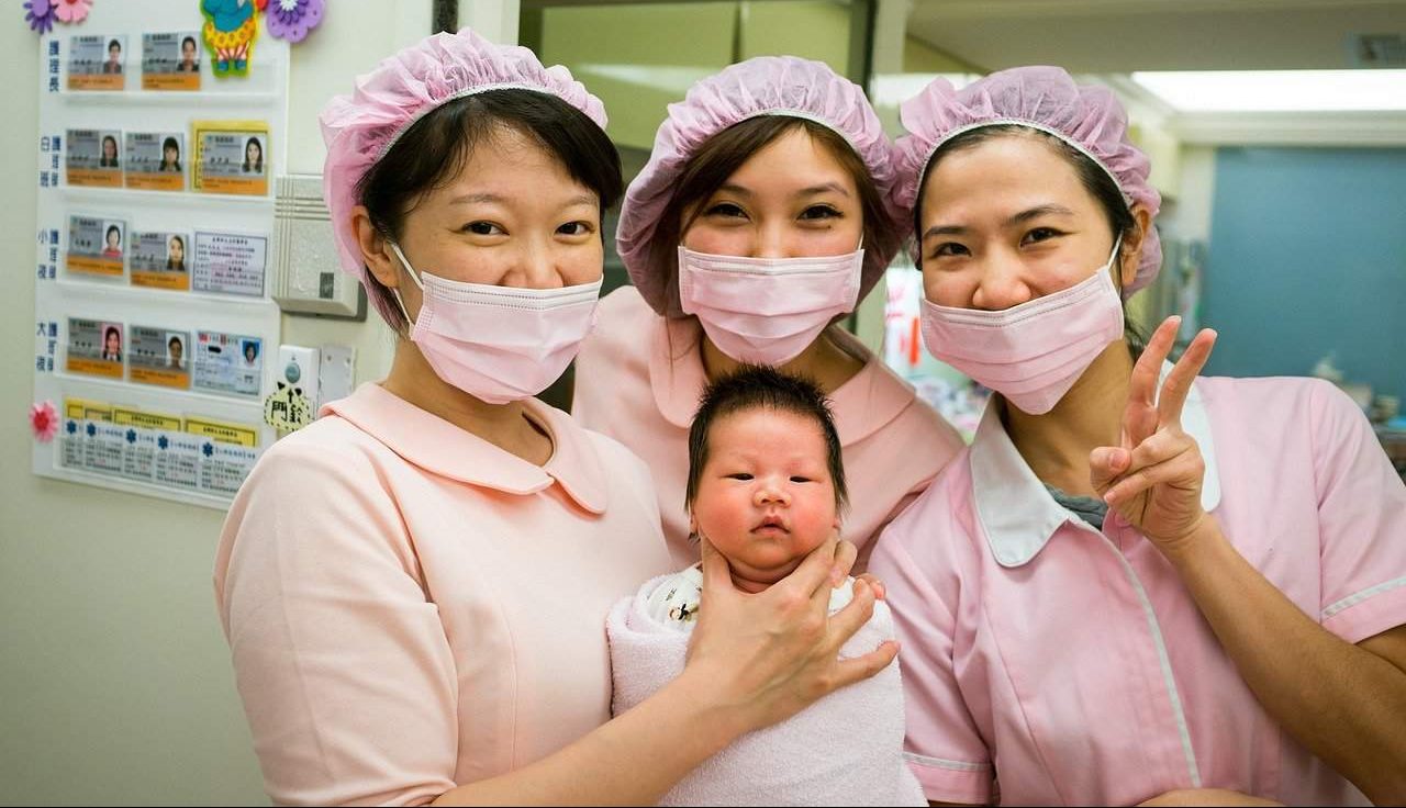 midwife smiling newborn