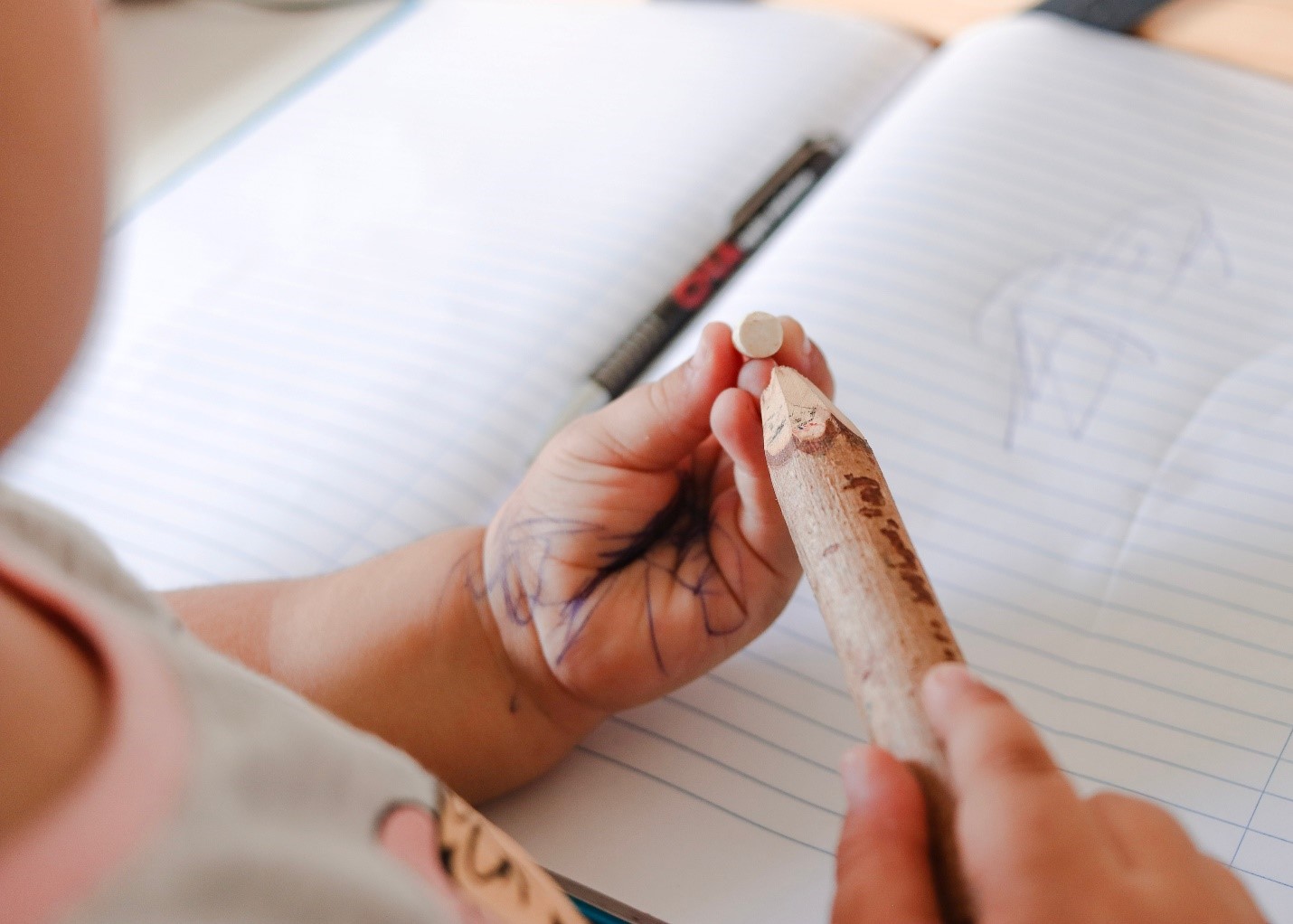 baby holding pencil