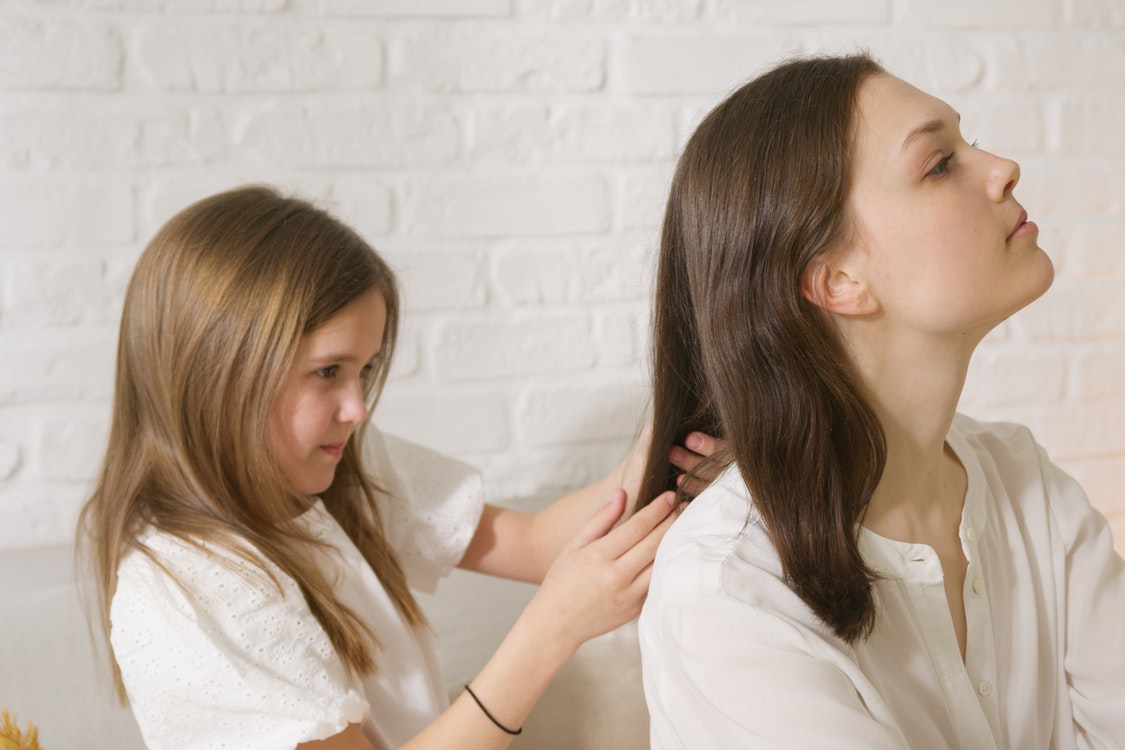 kid braiding mother hair