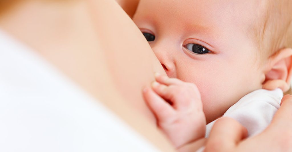 baby looking at something while being breastfed