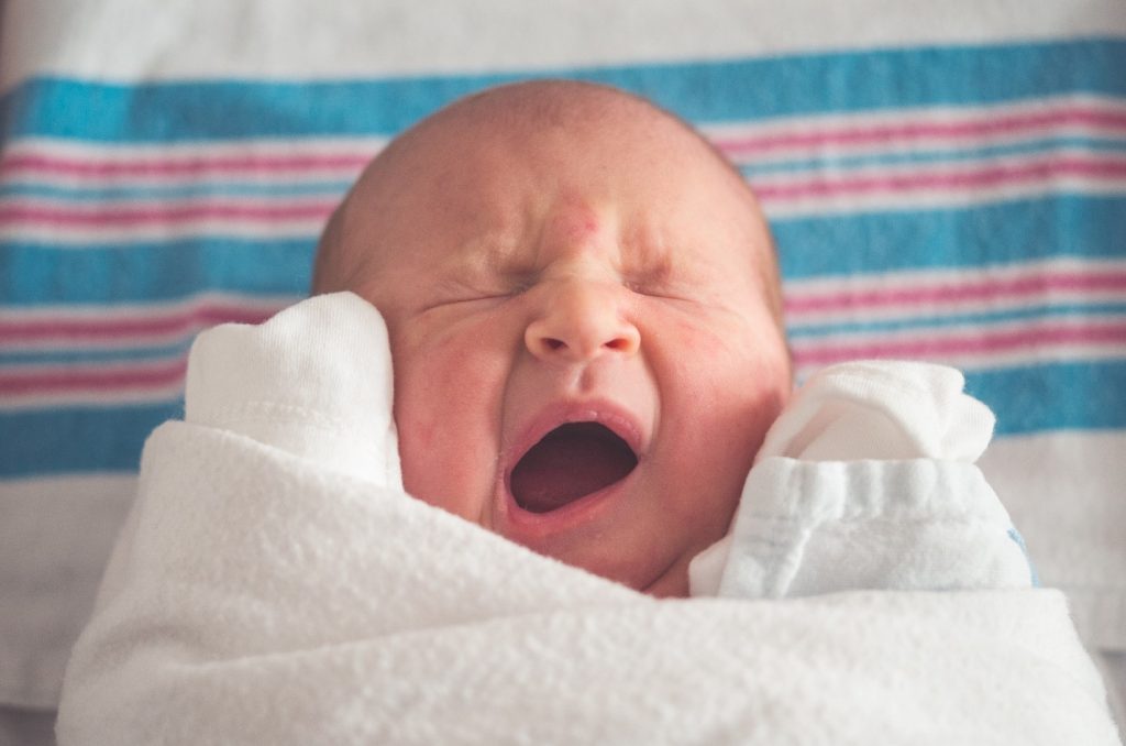 baby in a blanket yawning