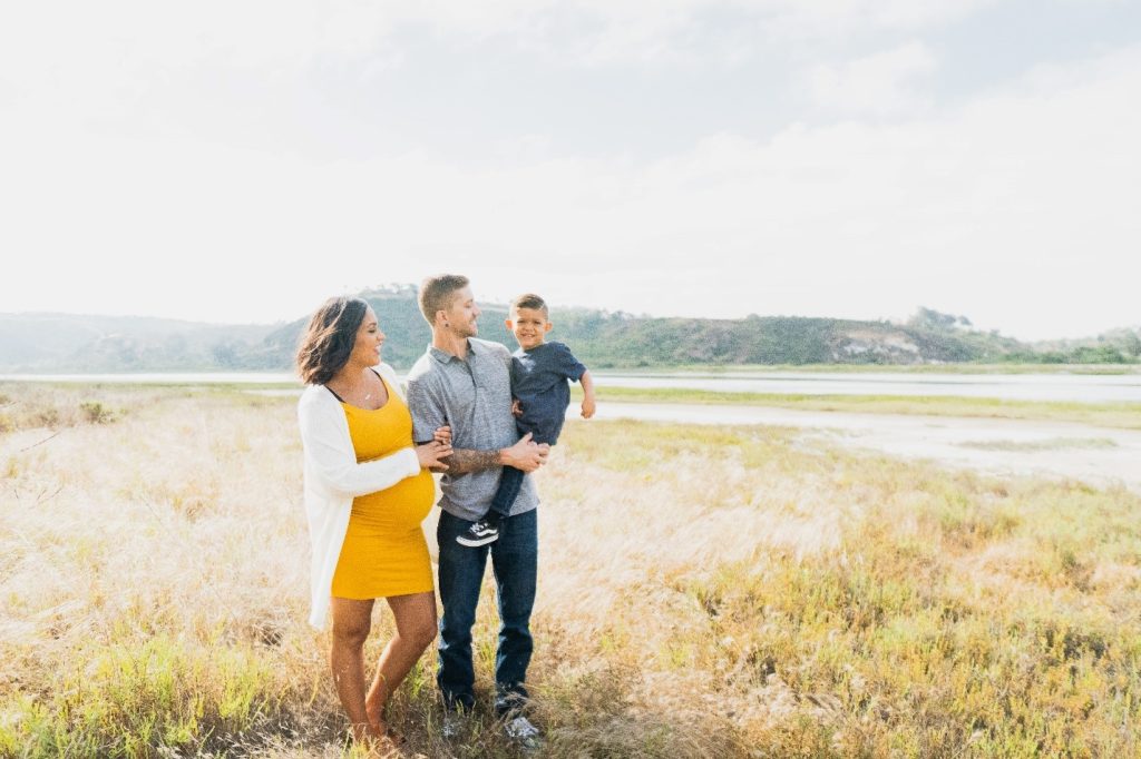 family standing on a meadow