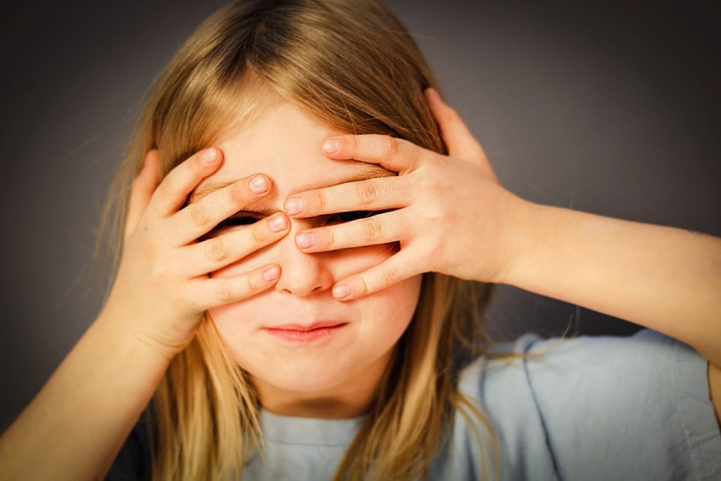 girl covering her eyes