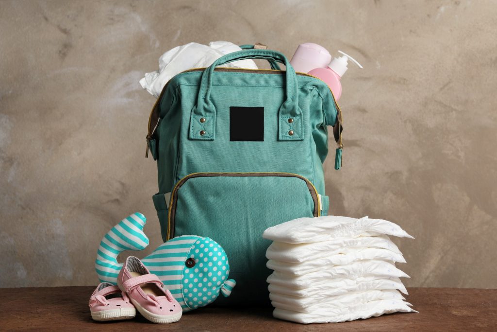 green backpack filled with diapers