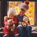 girl with her baby brother holding teddy bear