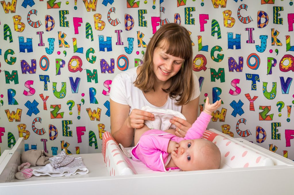 mom changing her baby's diaper