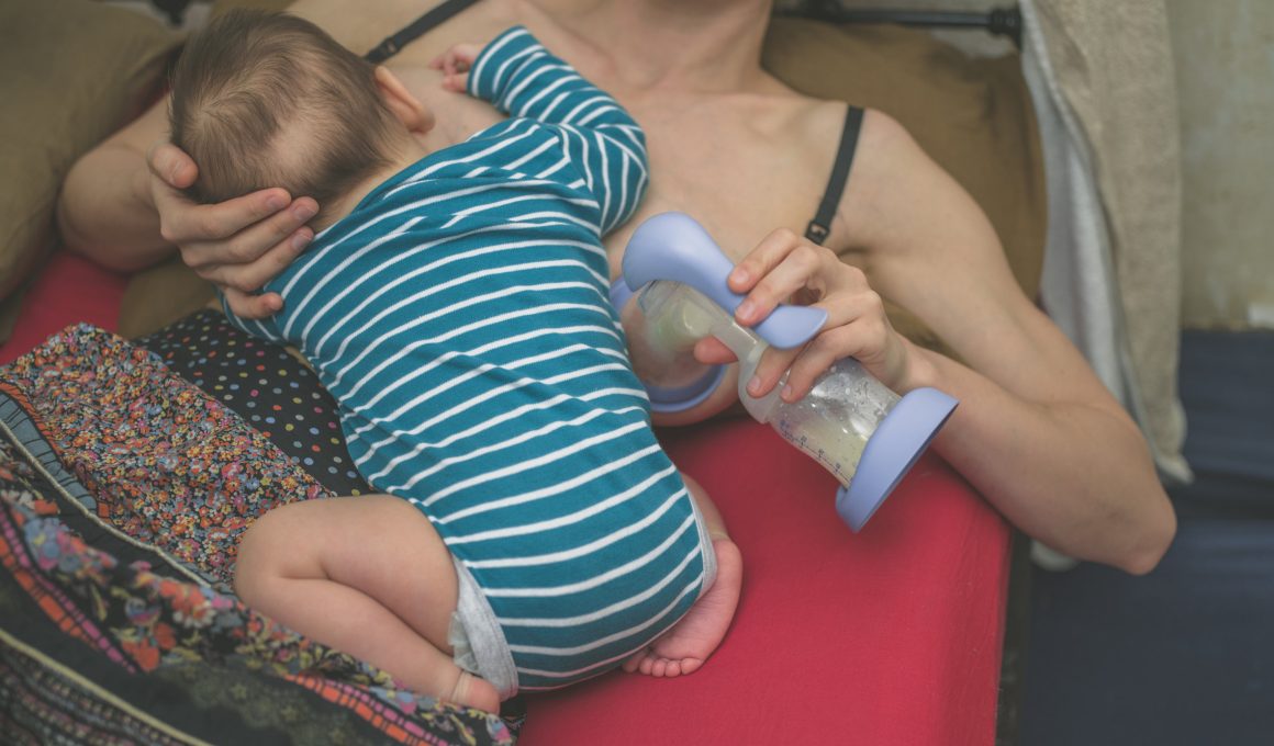 Mother breastfeeding and expressing milk