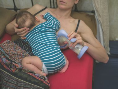 Mother breastfeeding and expressing milk
