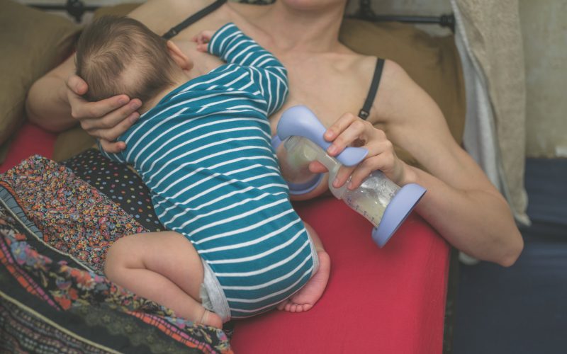 Mother breastfeeding and expressing milk