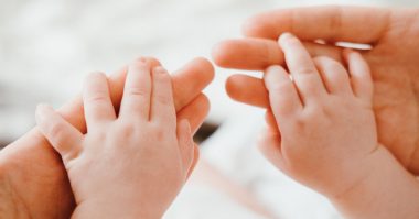 mother holding a baby's hand