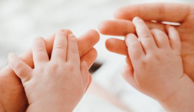 mother holding a baby's hand