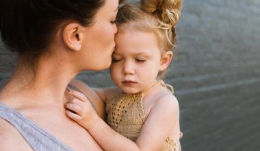 mother kissing her baby girl