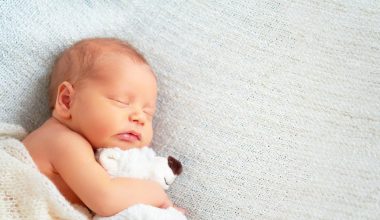 baby sleeping with teddy bear