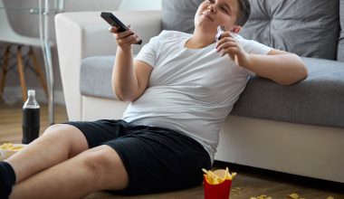 boy watching tv while eating fries
