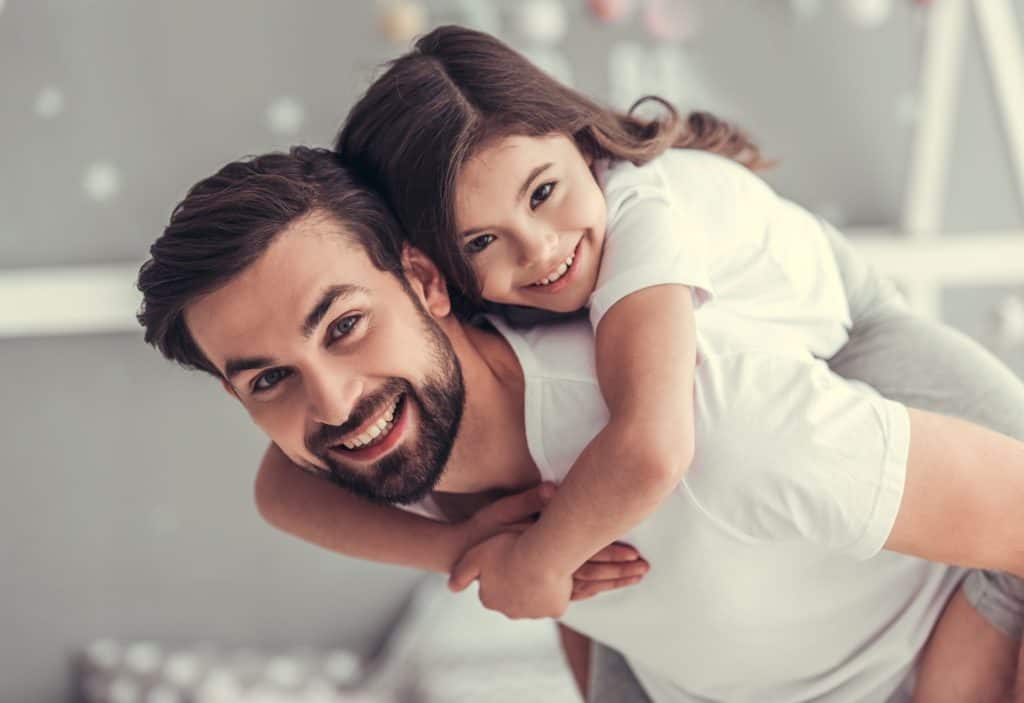 daughter piggyback riding on her dad