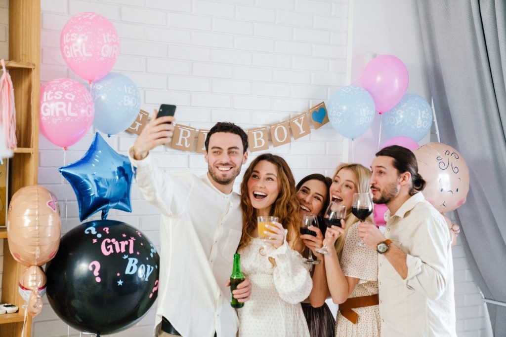 friends taking selfie on gender reveal party