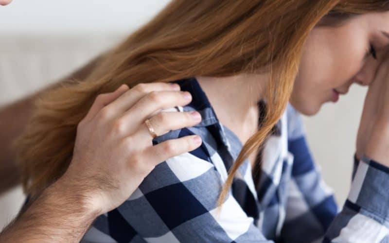 husband comforting his wife after having miscarriage