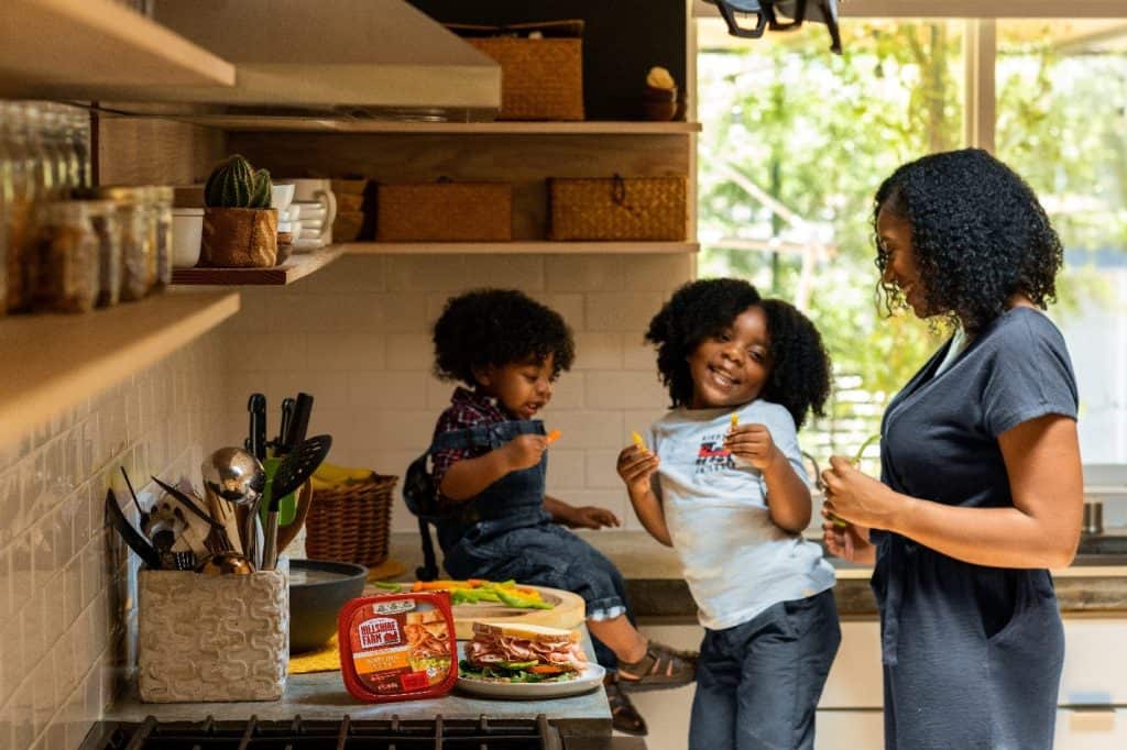 mom and her children dancing in the kitchen