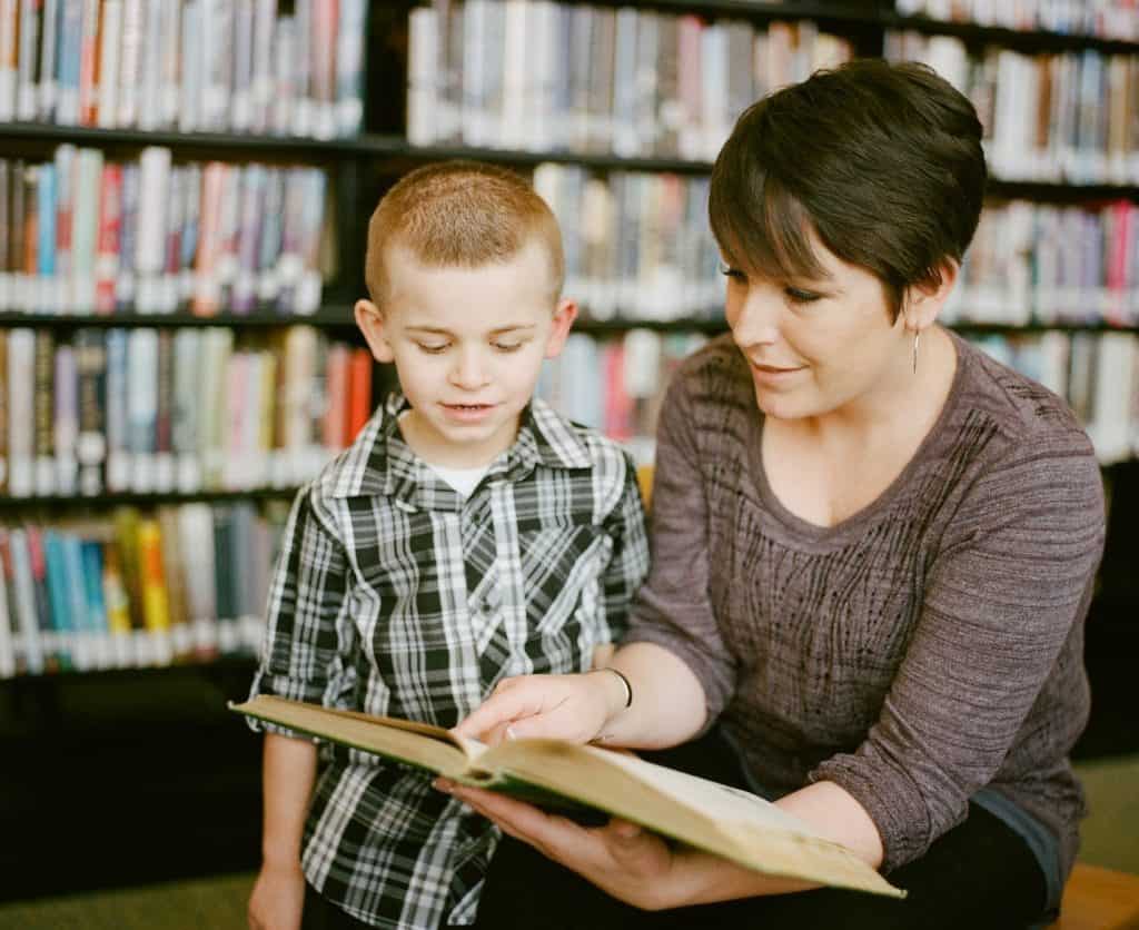 mother teaching her son to read