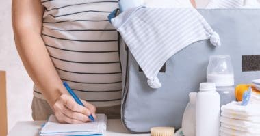 pregnant woman preparing diaper caddy