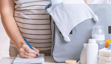 pregnant woman preparing diaper caddy