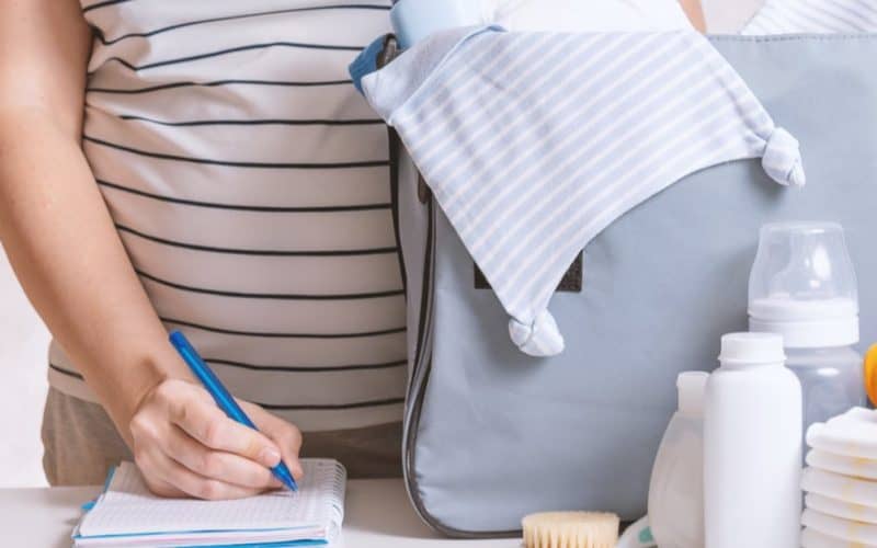 pregnant woman preparing diaper caddy