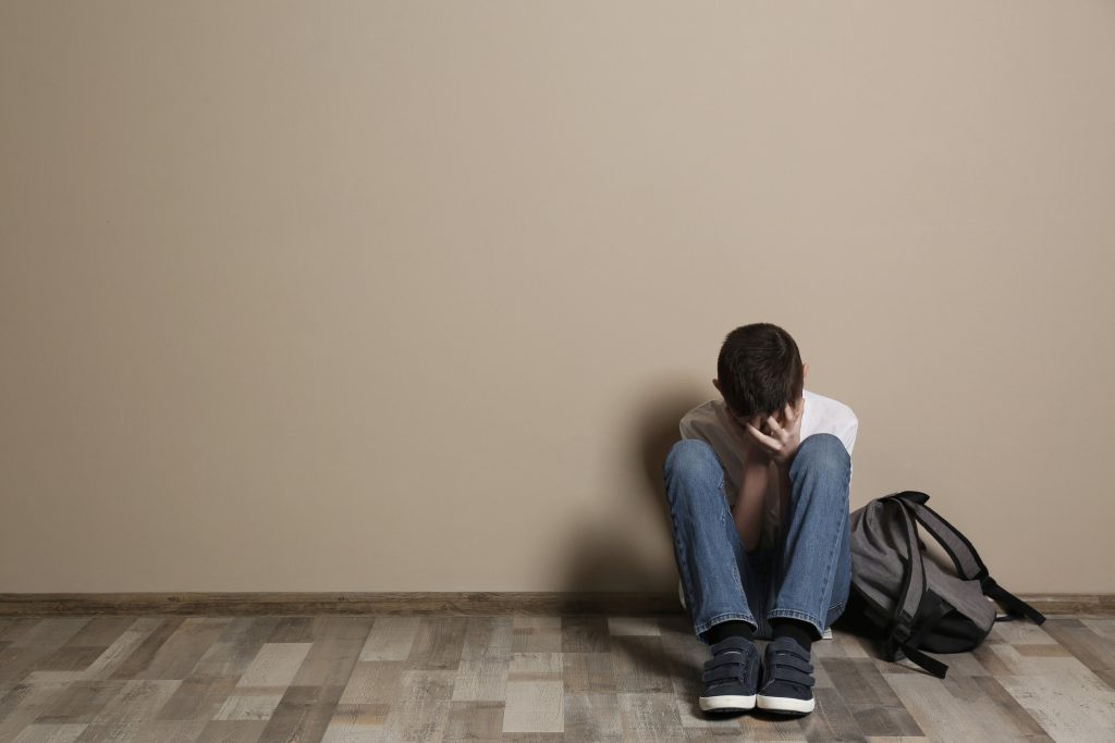 sad 14-year-old sitting alone