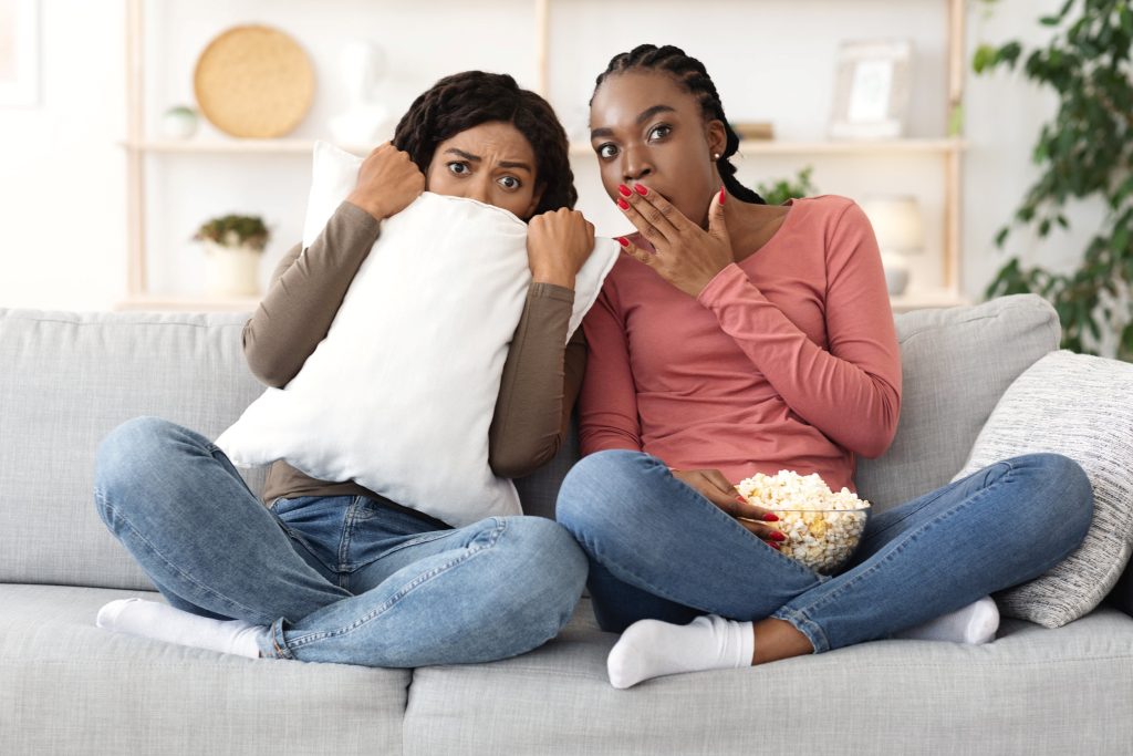 scared teenagers watching television