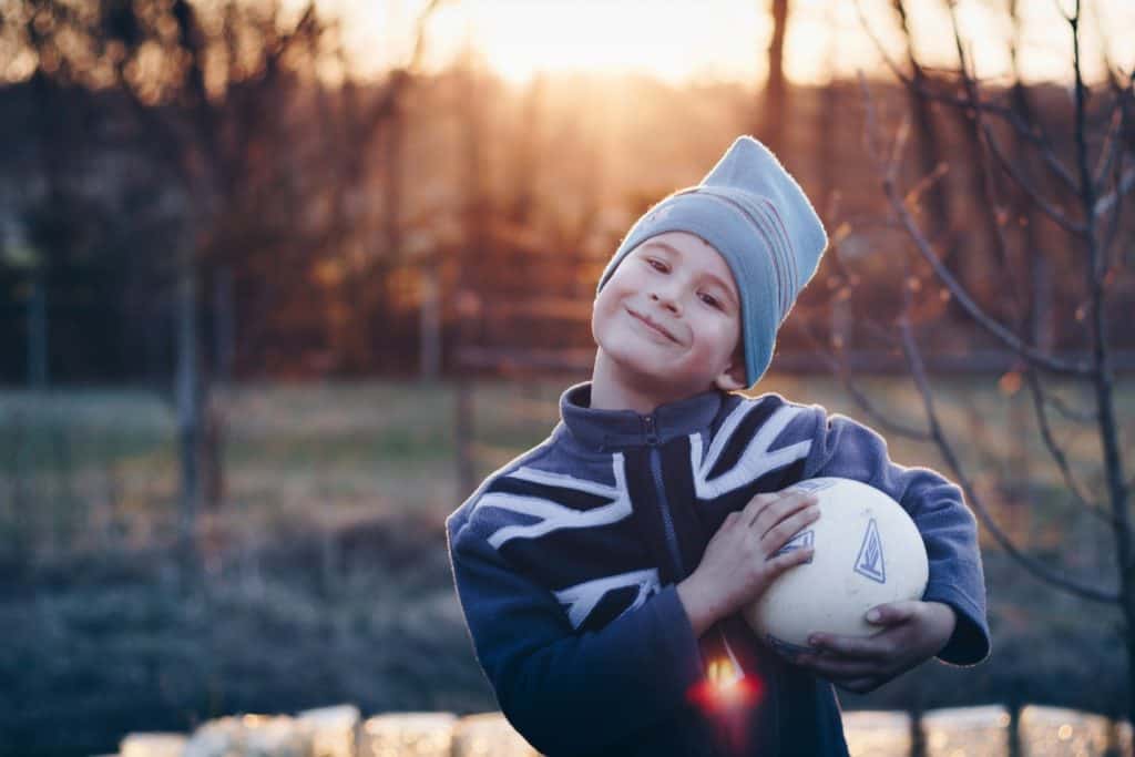 smiling kid holding a ball