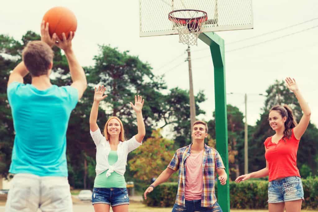teenagers playing basketball
