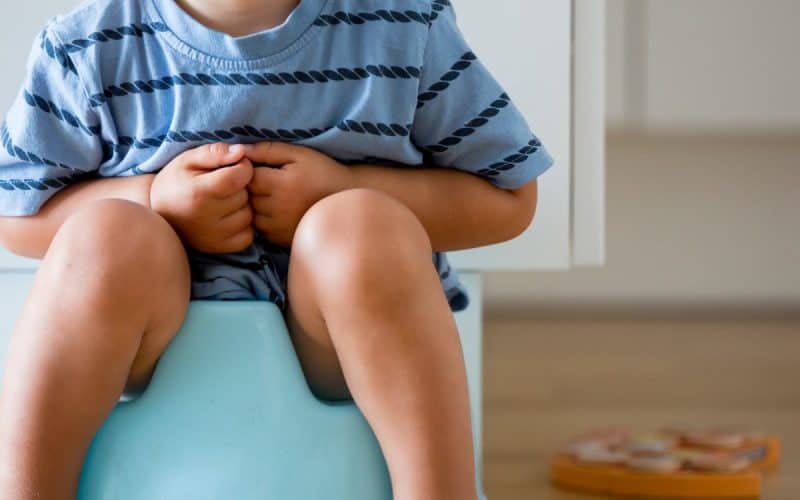 toddler sitting on potty