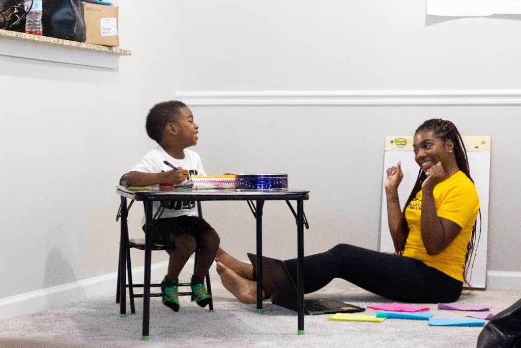 woman entertaining a toddler