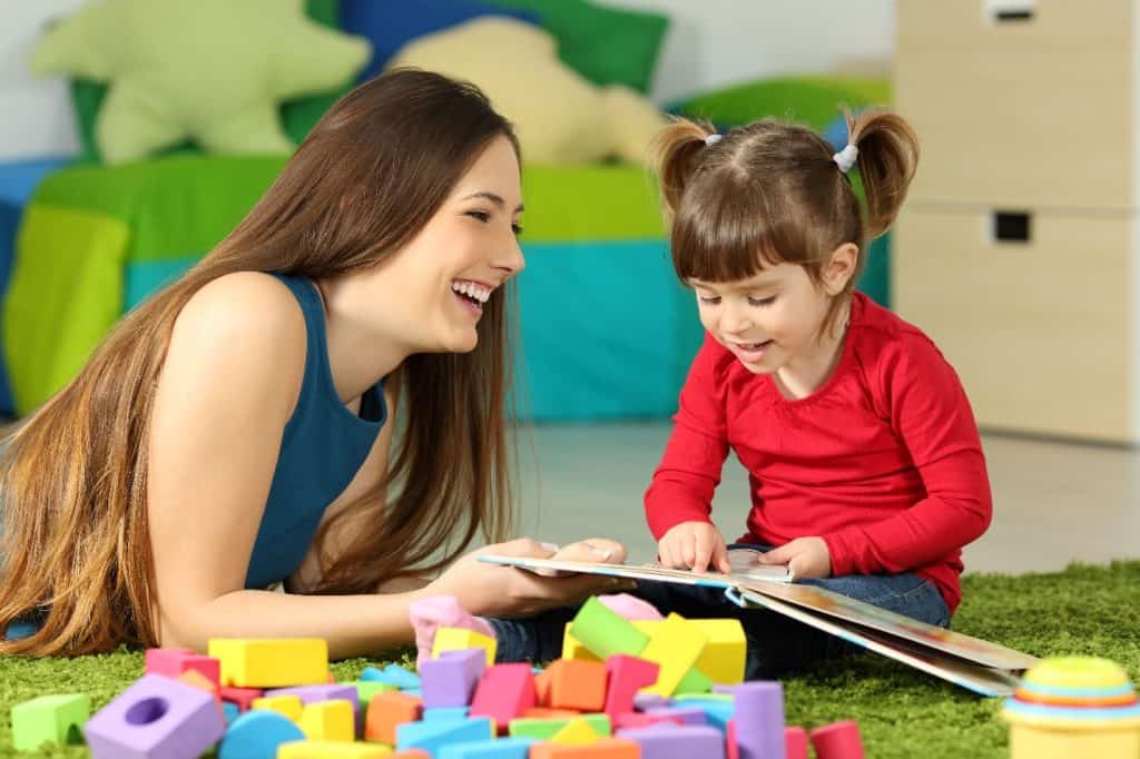 woman laughing with a toddler