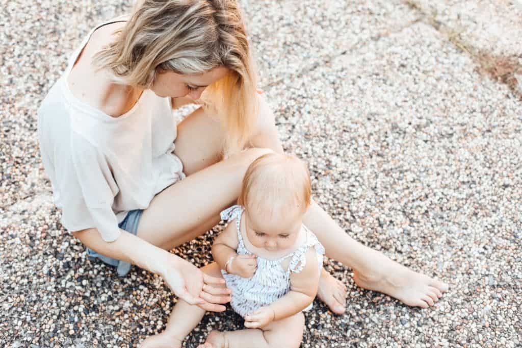 woman lending her hands to a baby