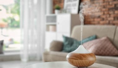 Aroma oil diffuser on table at home. Air freshener