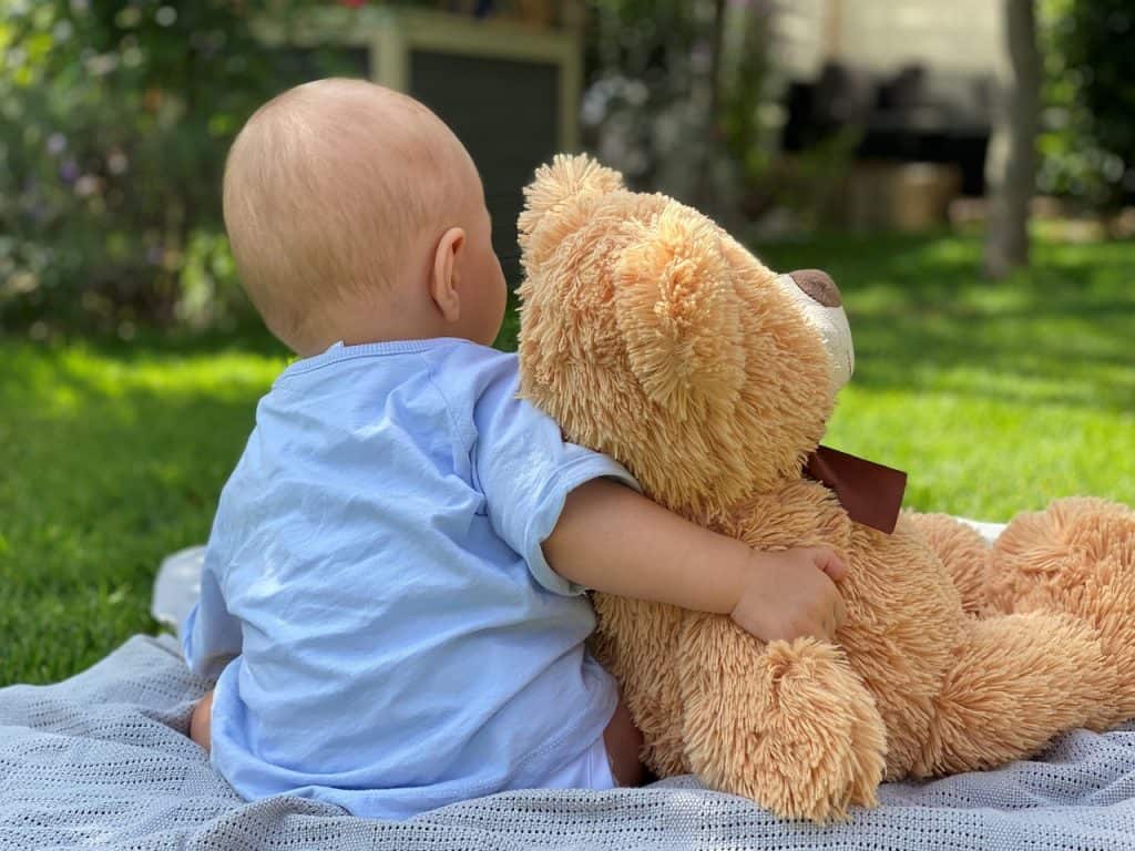 baby boy hugging teddy bear