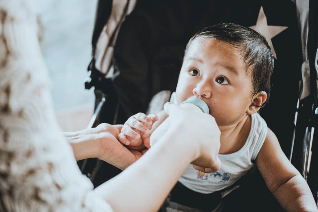 baby drinking milk from bottle