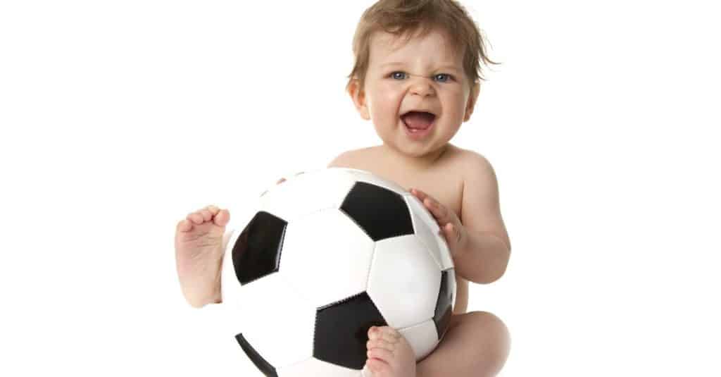 baby playing with football