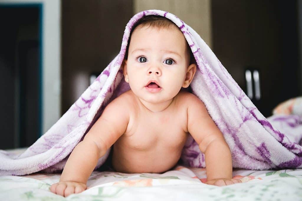 cute baby under a blanket