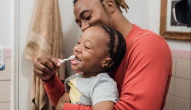 dad brushing son's teeth