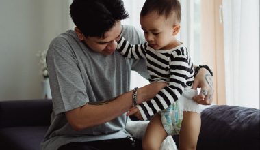 dad changing baby's diaper