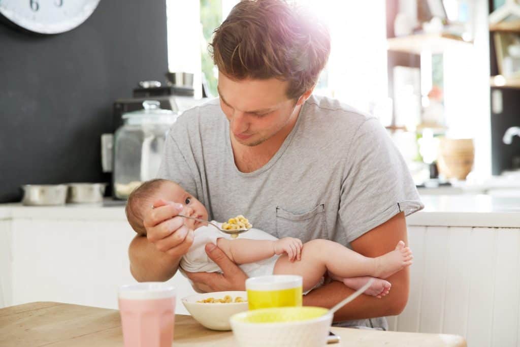 dad feeding baby