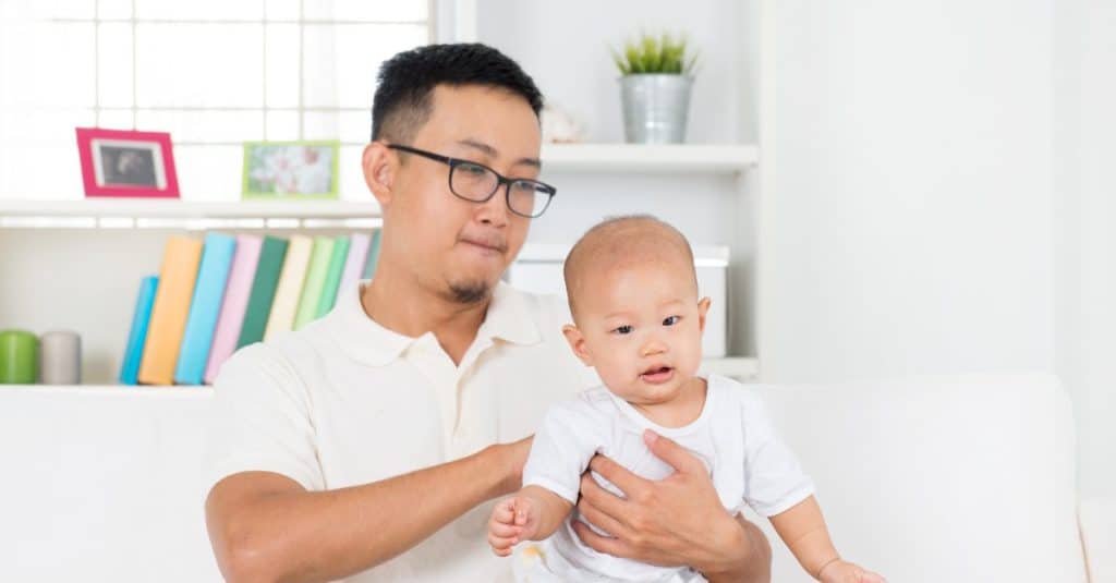 dad massaging baby's back