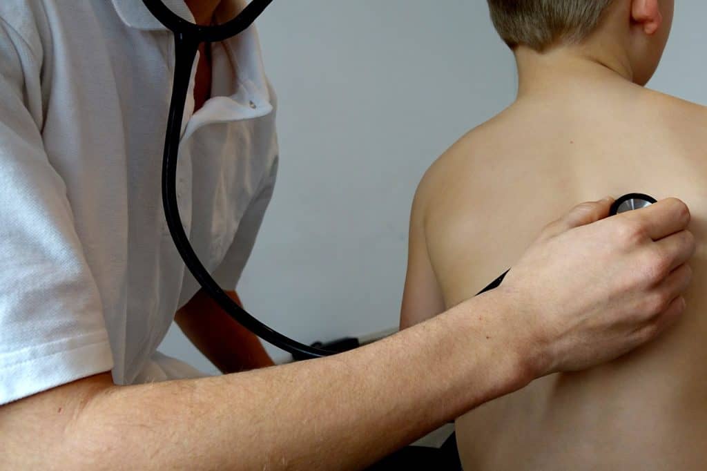 doctor checking up toddler's breathing