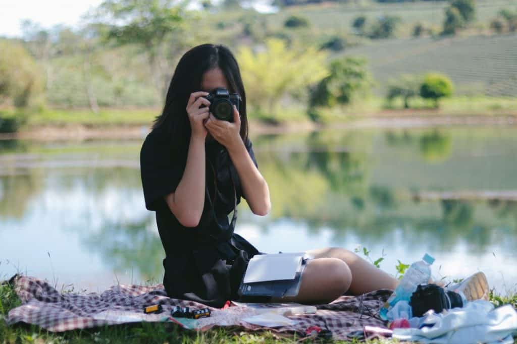 girl taking a picture with a dslr camera