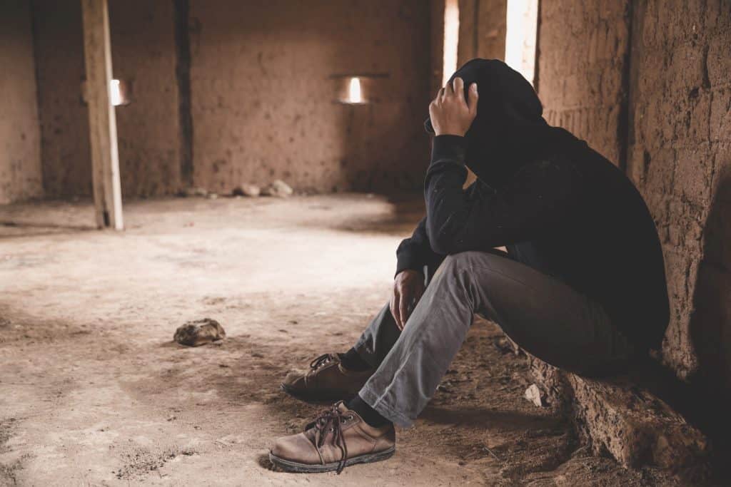 hooded man in abandoned house