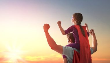 little girl and dad wearing a cape